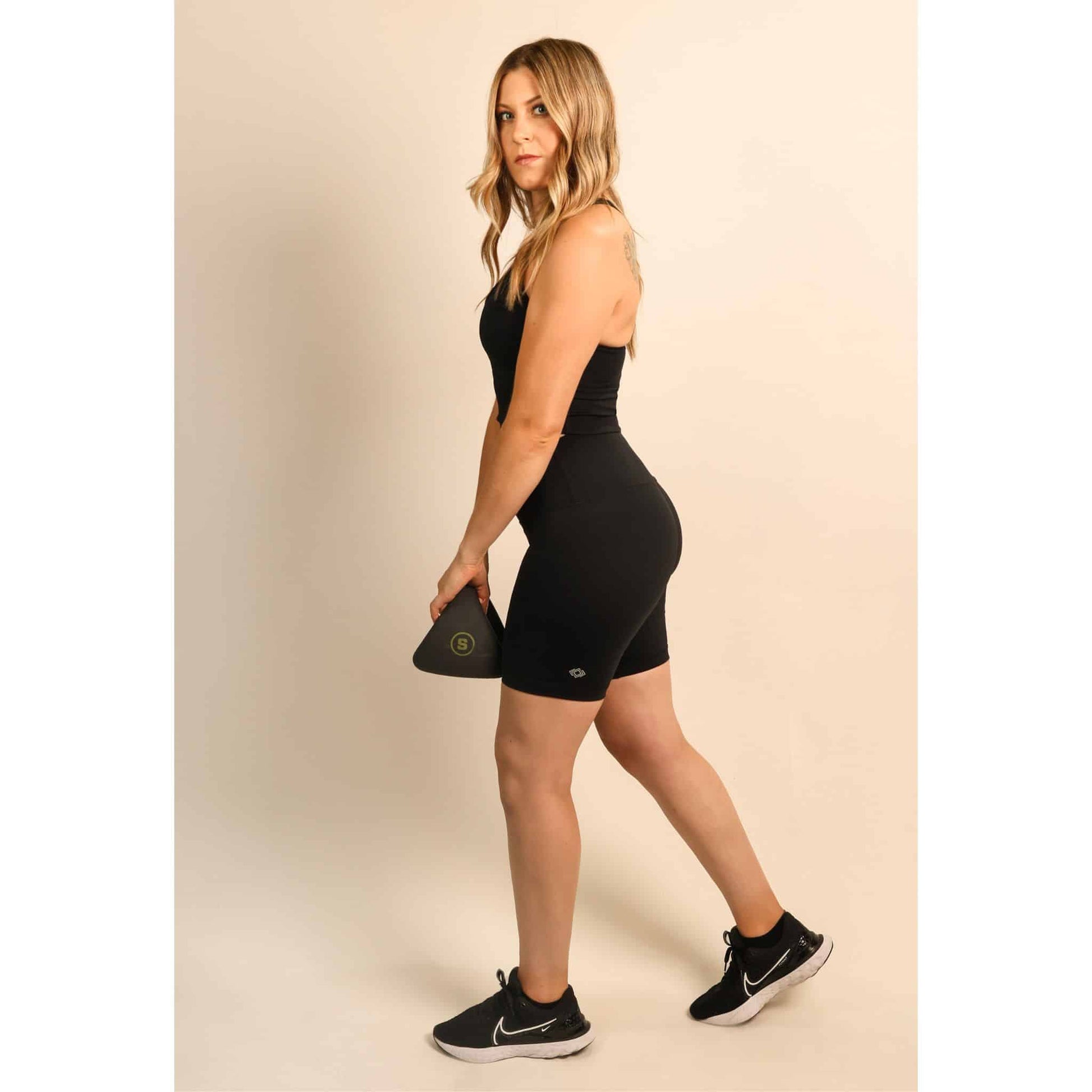 personal trainer wearing Quoia activewear black biker shorts set